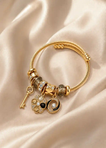 Multi Charm Gold Bangle (Emotional Lens: Memory, Continuity)